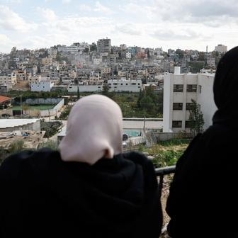 Israeli heavy machinery demolishes a Palestinian building at Nur Shams refugee camp