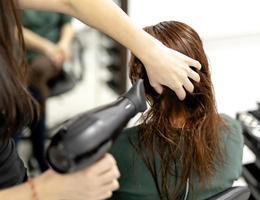 Professional,Hairdresser,Using,Modern,Diffuser,Hair,Dryer,To,Dry,And