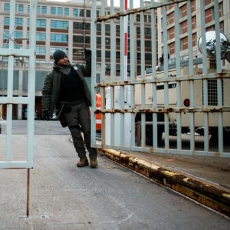 A worker closes a gate at the Metropolitan Detention Center in Brooklyn, New York
