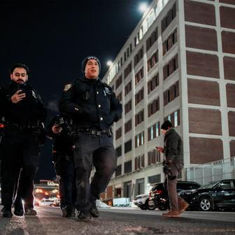 NYPD officers patrol outside of the Metropolitan Detention Center in Brooklyn , New York