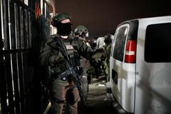 Department of Justice Federal Officers stand guard outside of the Metropolitan Detention Center in Brooklyn , New York