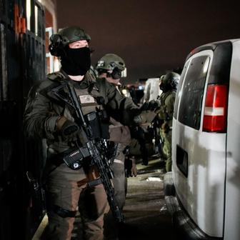 Department of Justice Federal Officers stand guard outside of the Metropolitan Detention Center in Brooklyn , New York