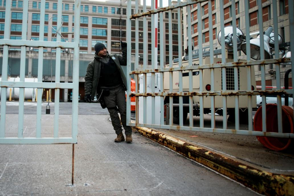 A worker closes a gate at the Metropolitan Detention Center in Brooklyn, New York