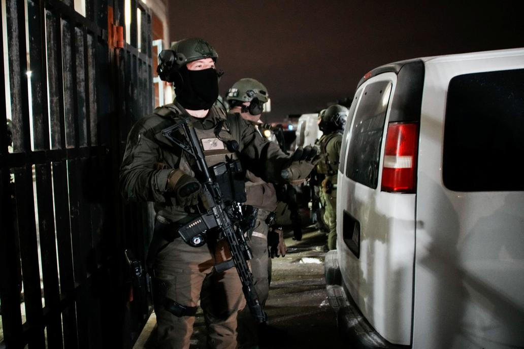 Department of Justice Federal Officers stand guard outside of the Metropolitan Detention Center in Brooklyn , New York