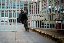 A worker closes a gate at the Metropolitan Detention Center in Brooklyn, New York