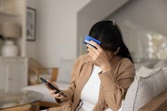 Tired,Upset,Young,Asian,Bank,Client,Getting,Money,Problems,,Finding