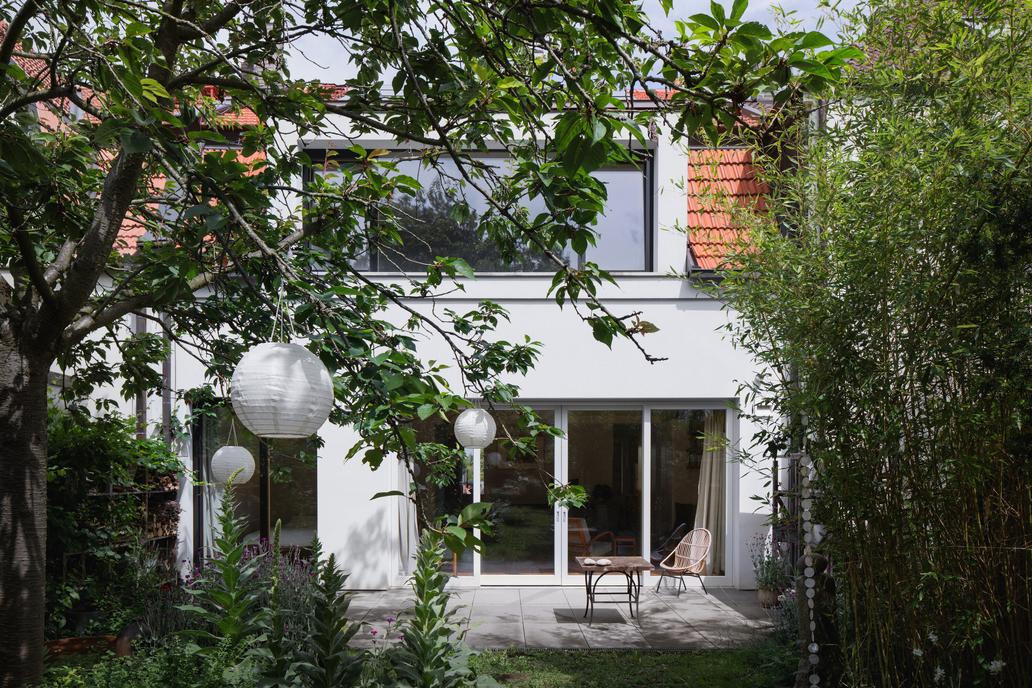 Nemovitost na první pohled vypadá klidně - barevně tlumená fasáda kombinuje jemnozrnnou a hrubou omítku s kamenným zrnem a tlumí výraz celé stavby.