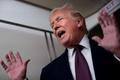 U.S. President Donald Trump speaks with members of the media aboard Air Force One en route to Joint Base Andrews
