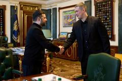 Ukraine's President Zelenskiy and newly appointed Defence Minister Fedorov shake hands before their meeting in Kyiv