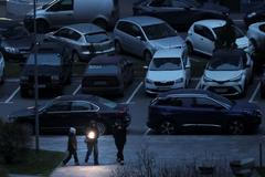 People use a flashlight as they walk during a power blackout in Kyiv