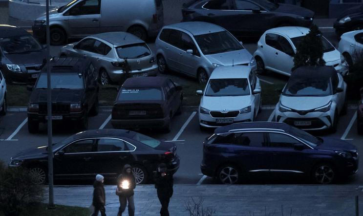 People use a flashlight as they walk during a power blackout in Kyiv