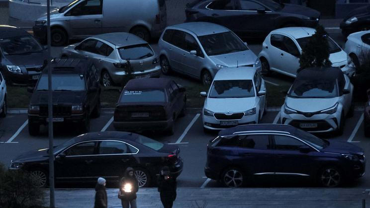 People use a flashlight as they walk during a power blackout in Kyiv