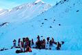 Rescue workers stand near the site where four skiers were killed in an avalanche in Pongau district