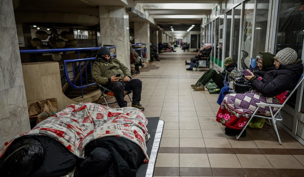 People take shelter inside a metro station during a Russian missile and drone attack, in Kyiv