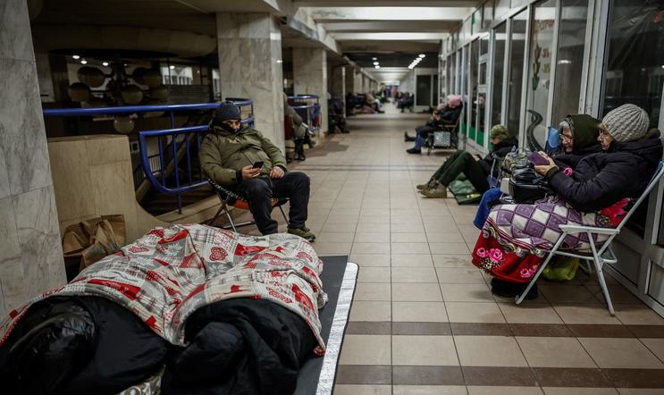 People take shelter inside a metro station during a Russian missile and drone attack, in Kyiv