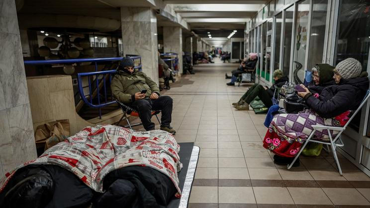 People take shelter inside a metro station during a Russian missile and drone attack, in Kyiv