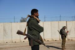 Members of the Syrian army stand guard at the al-Shaddadi prison after the withdrawal of the Syrian Democratic Forces and its takeover by the Syrian army, in al-Shaddadi