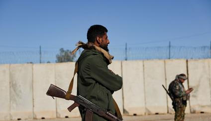 Members of the Syrian army stand guard at the al-Shaddadi prison after the withdrawal of the Syrian Democratic Forces and its takeover by the Syrian army, in al-Shaddadi