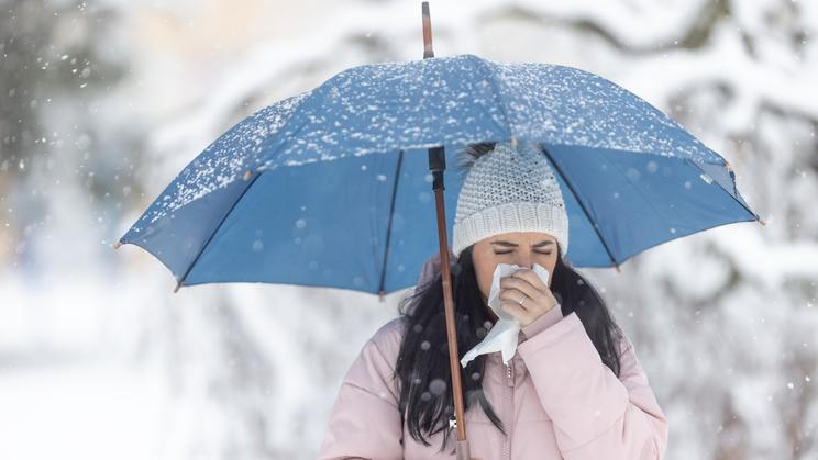 Woman,Holds,Umbrella,While,Clearing,Her,Nose,Due,To,Winter