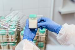 Overhead,Shot,Shows,Gloved,Hands,Lifting,A,Small,Container,Of