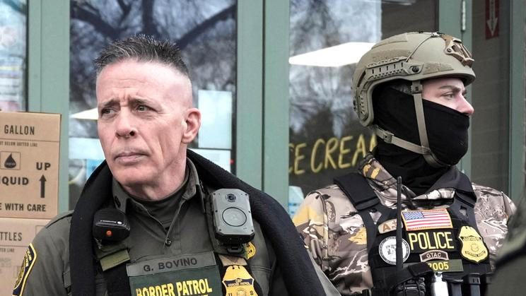 Border Patrol commander Greg Bovino's convoy stops at a gas station in Columbia Heights