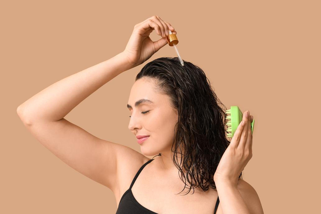 Beautiful,Young,Woman,With,Hair,Scalp,Massager,And,Cosmetic,Oil