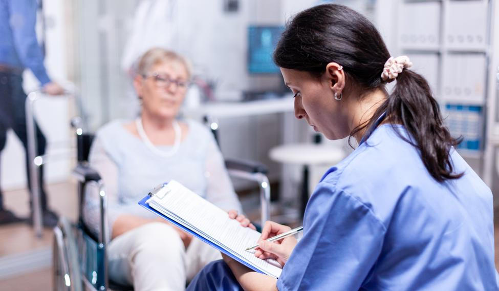 ["Nurse writing on clipboard"]