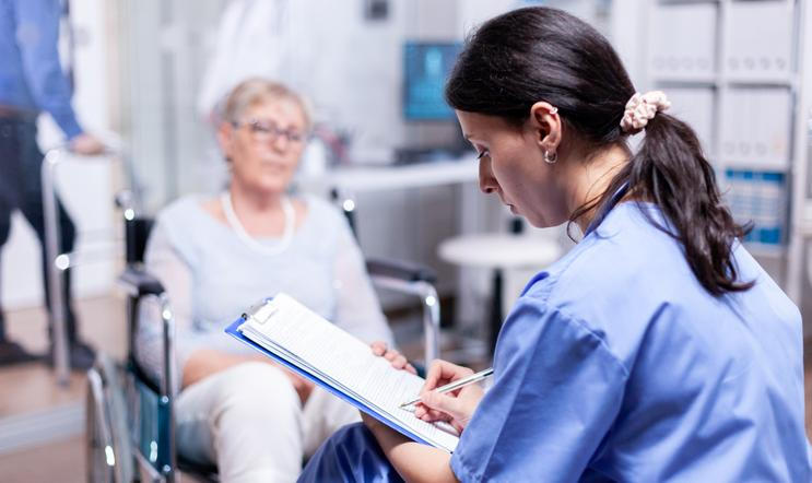 ["Nurse writing on clipboard"]