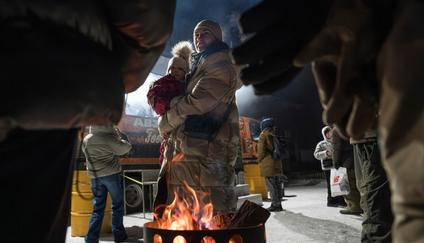 Ukrajinci mají za sebou další neklidnou a mrazivou noc. Protože Rusové pokračují v útocích především na ukrajinskou energetiku, část země zůstává bez proudu. Snímek Kyjevanů hřejících se u ohně na náměstí, kde veteráni rozdávají teplé jídlo a nápoje, byl pořízen v noci na neděli.