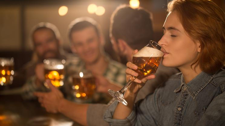 Side,View,Of,Beautiful,Woman,Holding,Glass,Of,Tasty,Beer