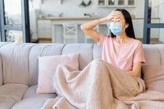 An,Ill,Asian,Woman,Wearing,Face,Mask,Sits,Alone,At
