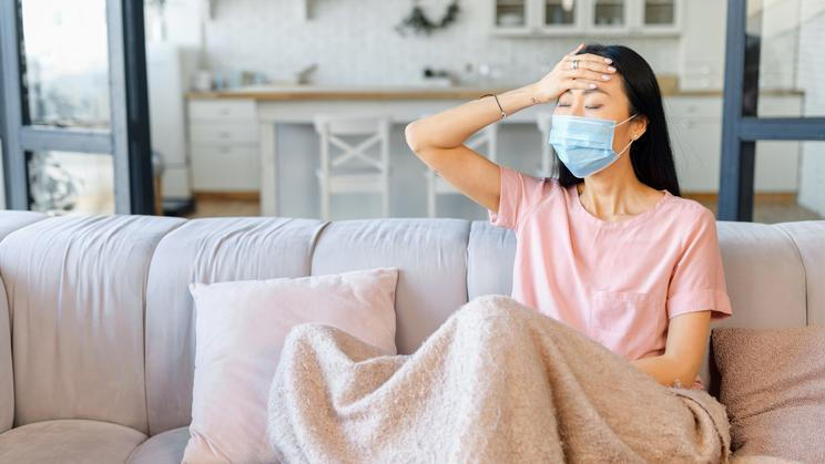 An,Ill,Asian,Woman,Wearing,Face,Mask,Sits,Alone,At