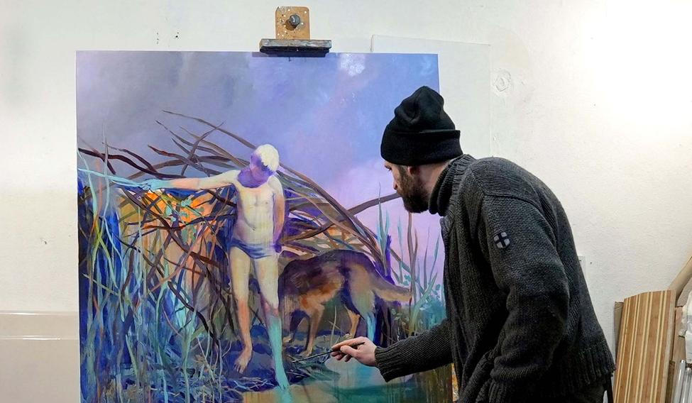 Ukrainian artist works at his studio during a power blackout in Kyiv