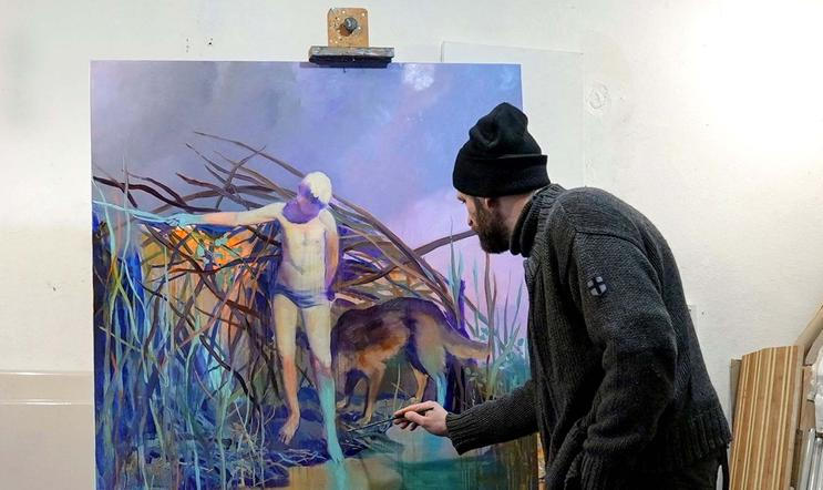 Ukrainian artist works at his studio during a power blackout in Kyiv