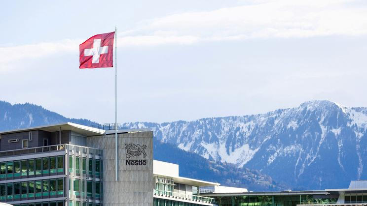 FILE PHOTO: A Swiss flag flutters on the headquarters of Nestle in Vevey