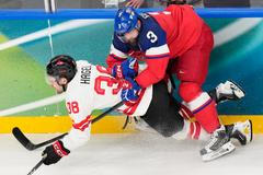 Radko Gudas (3) a Brandon Hagel v zápase Česko - Kanada na ZOH 2026