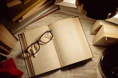 Top,View,Open,Book,With,Glasses,On,Top,Surrounded,By