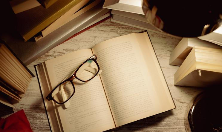Top,View,Open,Book,With,Glasses,On,Top,Surrounded,By