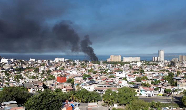 Smoke billows, following a military operation in which a government source said Mexican drug lord Nemesio Oseguera, known as "El Mencho," was killed, in Puerto Vallarta