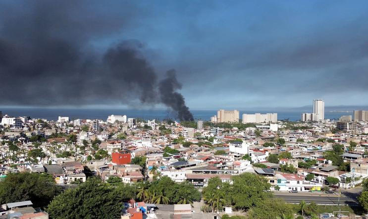 Smoke billows, following a military operation in which a government source said Mexican drug lord Nemesio Oseguera, known as "El Mencho," was killed, in Puerto Vallarta