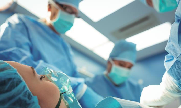 Team of surgeons performing operation in operation theater at hospital