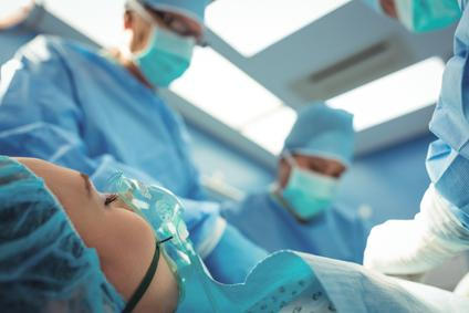 Team of surgeons performing operation in operation theater at hospital