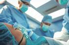 Team of surgeons performing operation in operation theater at hospital