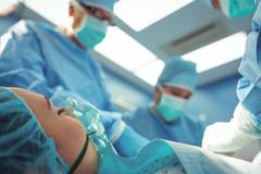 Team of surgeons performing operation in operation theater at hospital