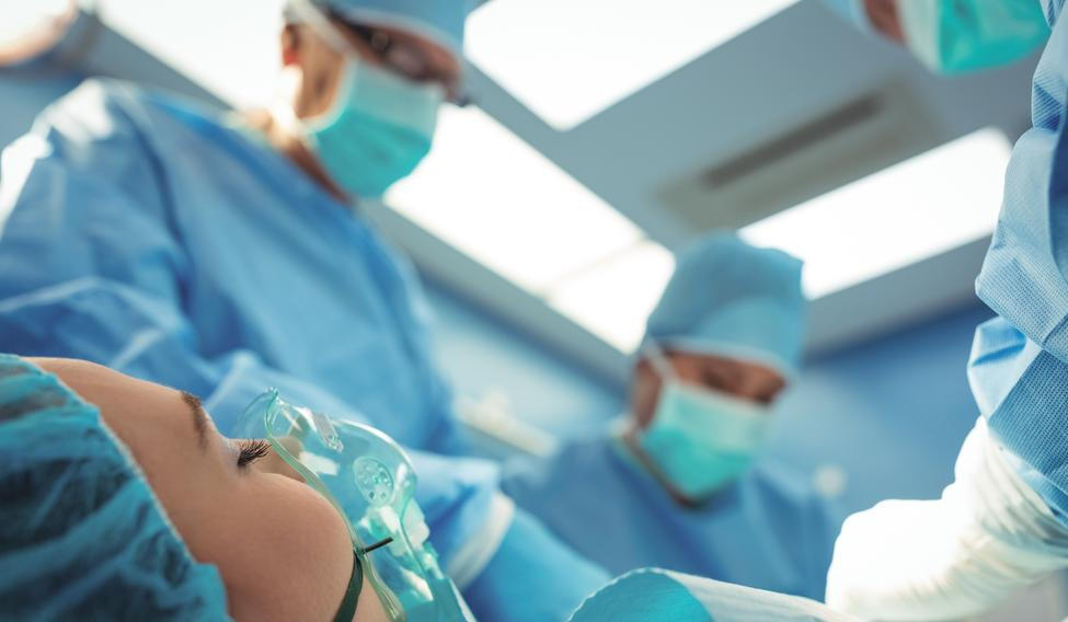 Team of surgeons performing operation in operation theater at hospital