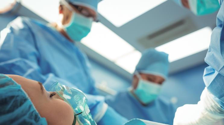 Team of surgeons performing operation in operation theater at hospital