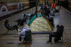People take shelter inside a metro station during a Russian missile and drone attack, in Kyiv