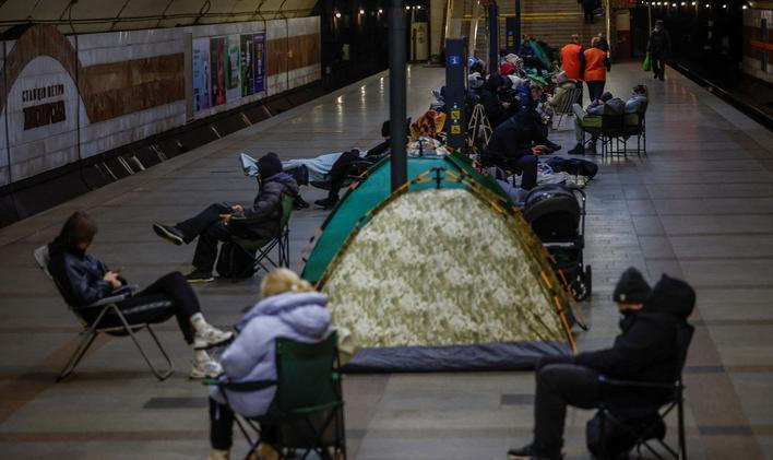 People take shelter inside a metro station during a Russian missile and drone attack, in Kyiv