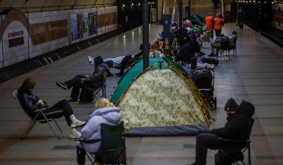People take shelter inside a metro station during a Russian missile and drone attack, in Kyiv