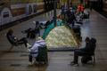 People take shelter inside a metro station during a Russian missile and drone attack, in Kyiv